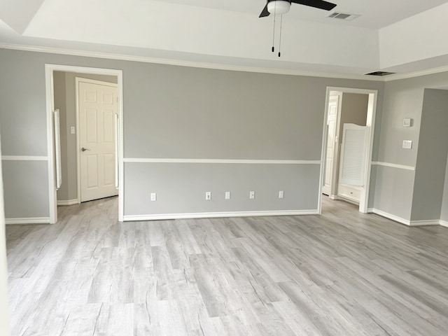 unfurnished room with light hardwood / wood-style floors, ceiling fan, and crown molding