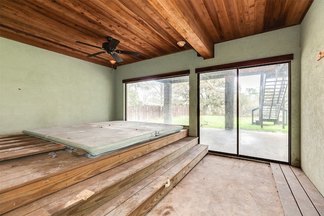 unfurnished sunroom with wood ceiling, ceiling fan, and beam ceiling