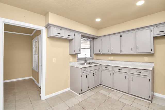 kitchen featuring light tile patterned floors and sink