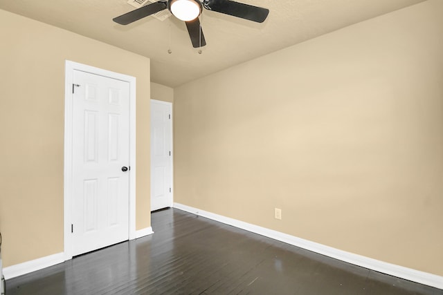 unfurnished room with ceiling fan and dark hardwood / wood-style floors