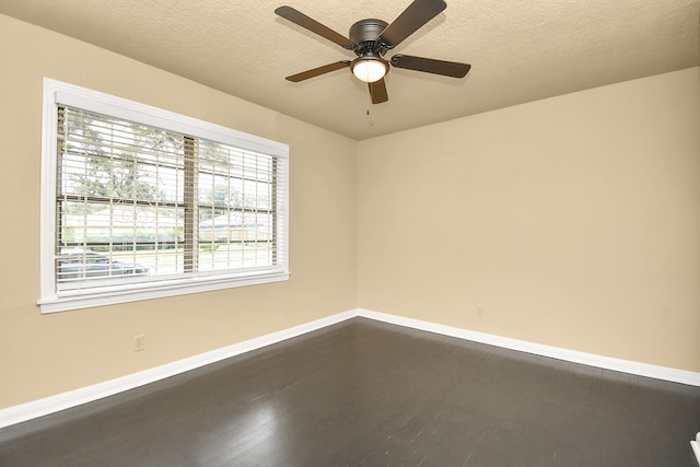 empty room with a textured ceiling, hardwood / wood-style flooring, and ceiling fan