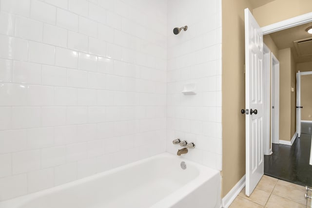 bathroom with tile patterned floors and tiled shower / bath combo