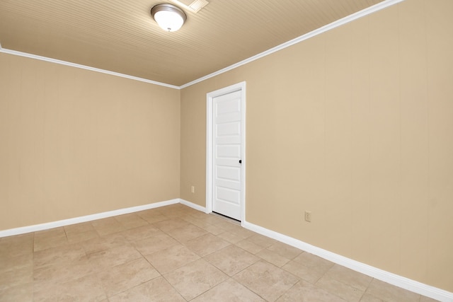 tiled spare room with crown molding