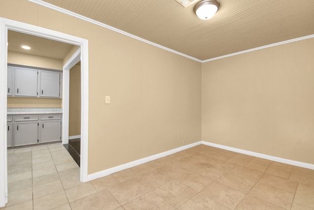 tiled empty room with crown molding