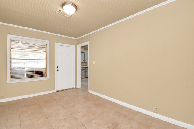 unfurnished room featuring ornamental molding and light tile patterned floors