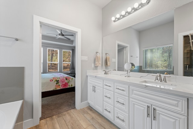 bathroom featuring vanity, a wealth of natural light, hardwood / wood-style flooring, and ceiling fan