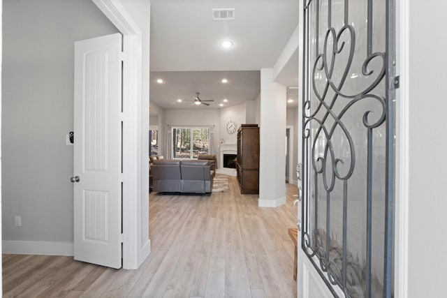 63 Shetland Ln, Coldspring, TX 77331 - entryway featuring a ceiling fan, light wood finished floors, baseboards, a fireplace, and recessed lighting