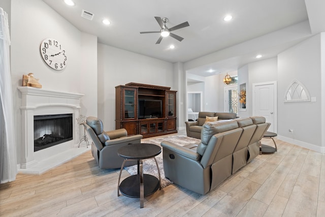 living room with light wood-type flooring and ceiling fan