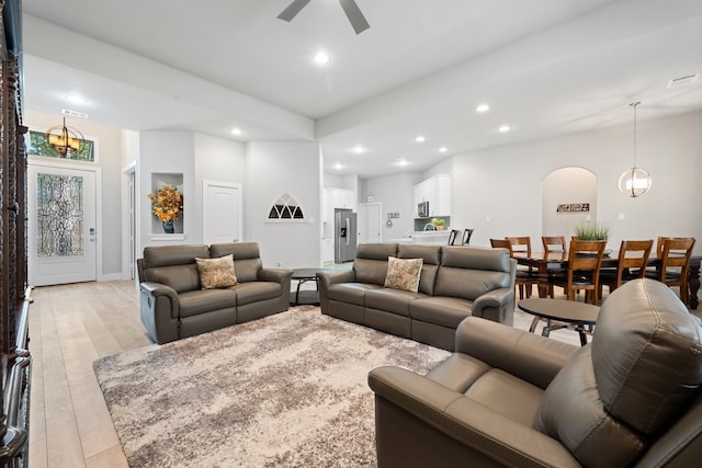 living room featuring light hardwood / wood-style flooring and ceiling fan