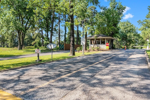 63 Shetland Ln, Coldspring, TX 77331 - view of asphalt road with traffic signs and street lighting