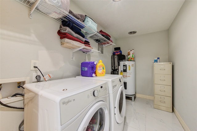 laundry area with water heater and separate washer and dryer