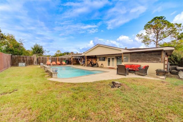 view of pool with an outdoor living space, a yard, and a patio area