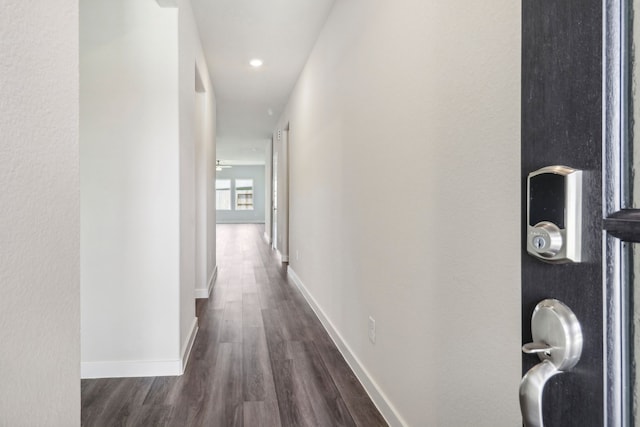 hall with recessed lighting, dark wood-style flooring, and baseboards