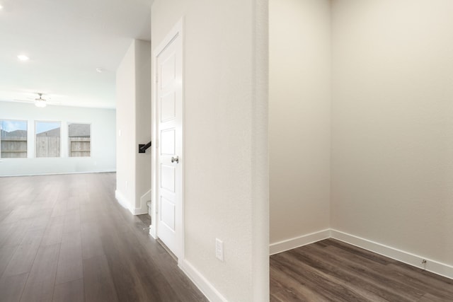 hall featuring dark wood-style floors and baseboards