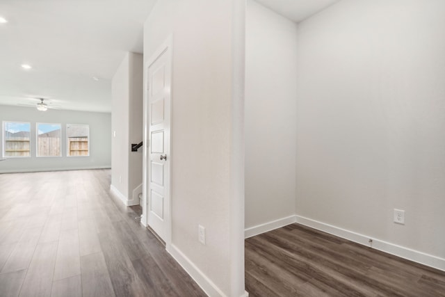 hall with dark wood-style floors and baseboards