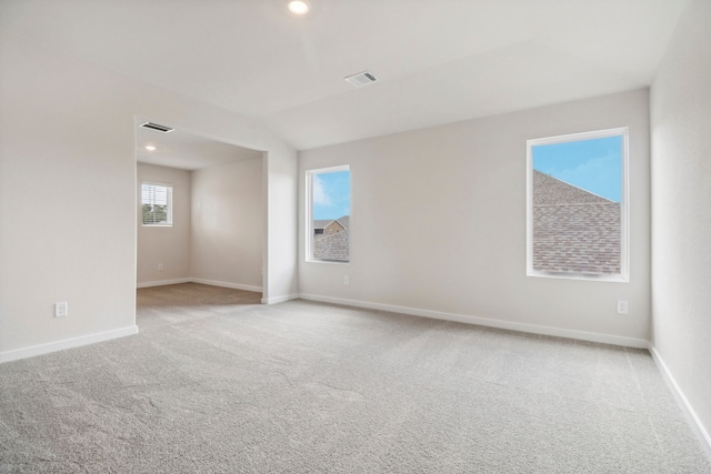 empty room featuring recessed lighting, baseboards, visible vents, and light colored carpet