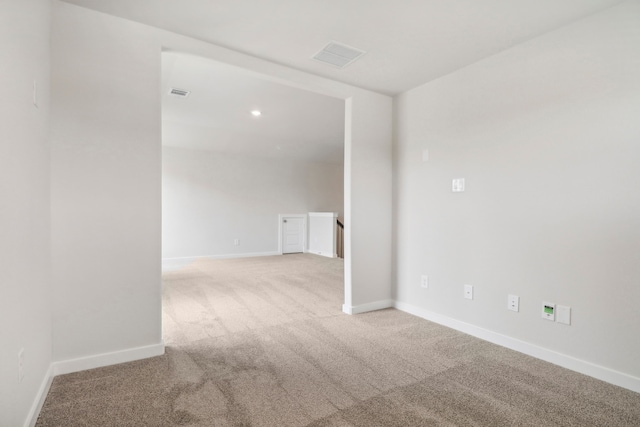 unfurnished room with carpet, visible vents, baseboards, and recessed lighting