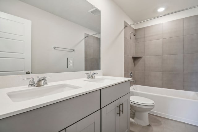 full bathroom featuring toilet, washtub / shower combination, a sink, and visible vents