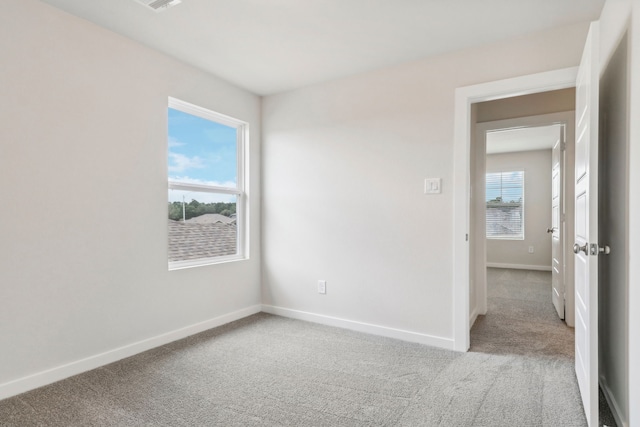 carpeted spare room with baseboards