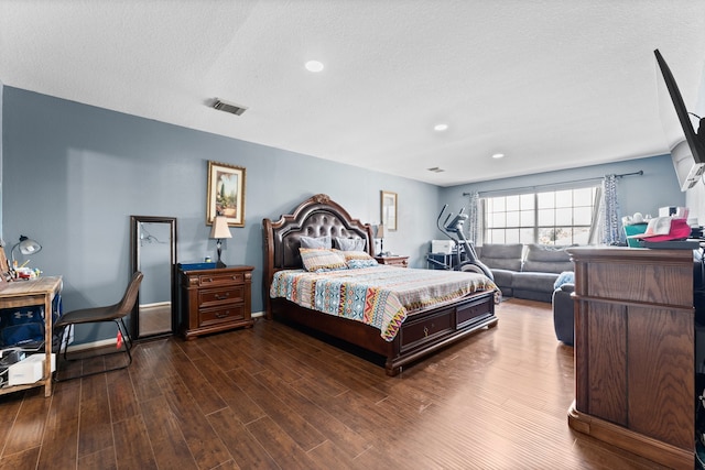 bedroom featuring dark wood-type flooring and a textured ceiling