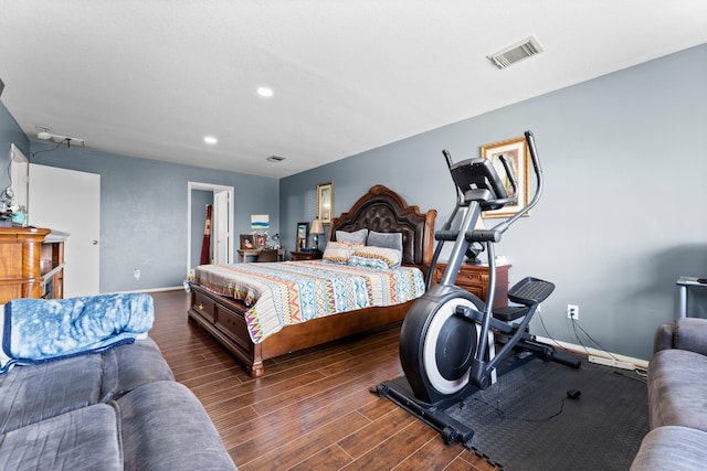 bedroom featuring dark hardwood / wood-style flooring and a spacious closet