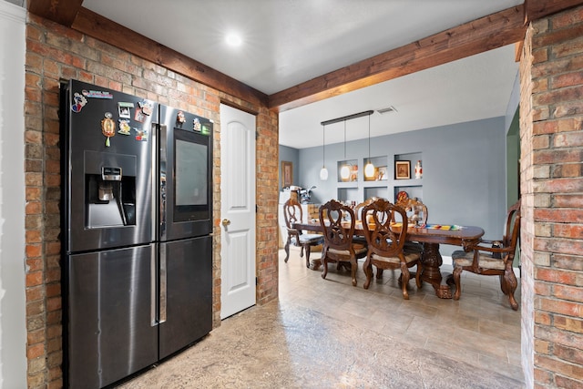 kitchen featuring pendant lighting, brick wall, beamed ceiling, and stainless steel fridge with ice dispenser