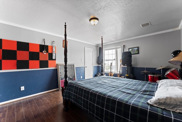 bedroom with wood-type flooring, ornamental molding, and a textured ceiling