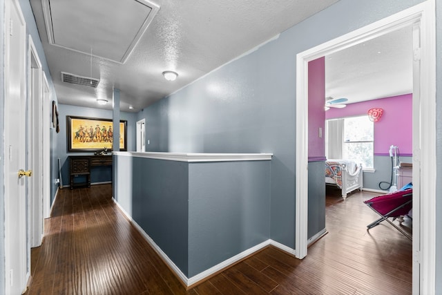 hall featuring dark hardwood / wood-style flooring and a textured ceiling