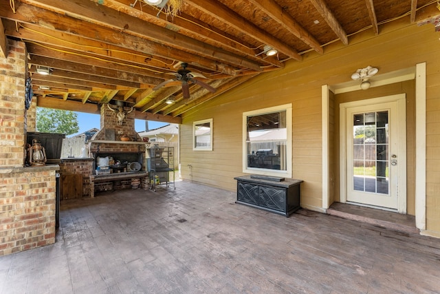 view of patio / terrace featuring ceiling fan and an outdoor stone fireplace