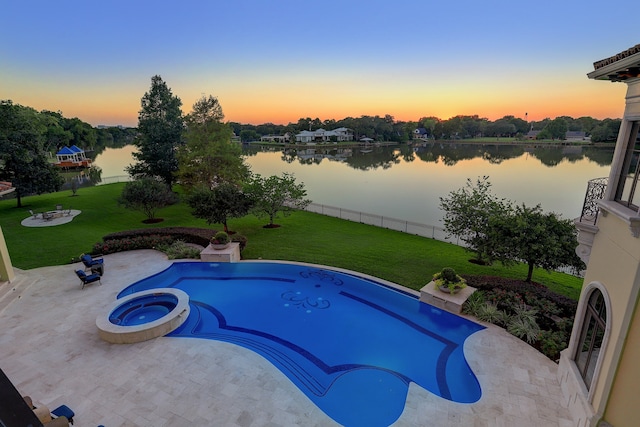 pool at dusk featuring a water view, an in ground hot tub, a yard, and a patio area