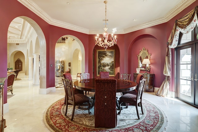 tiled dining space with french doors, ornate columns, crown molding, and a notable chandelier