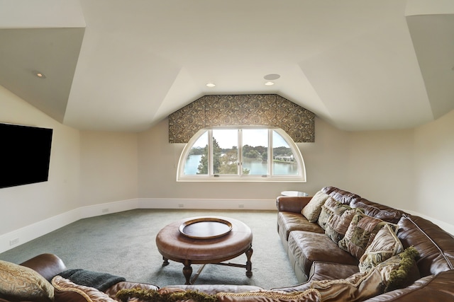 carpeted living room with a water view and vaulted ceiling