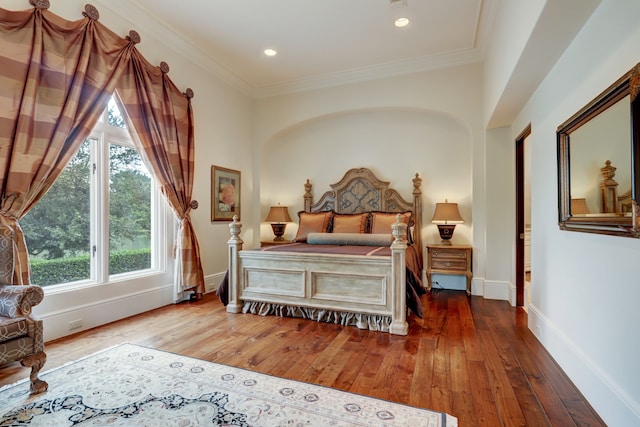 bedroom featuring hardwood / wood-style floors and crown molding