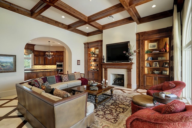 tiled living room featuring beamed ceiling, ornamental molding, an inviting chandelier, and coffered ceiling