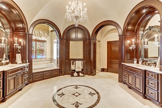 bathroom with a bath, a chandelier, vanity, and vaulted ceiling