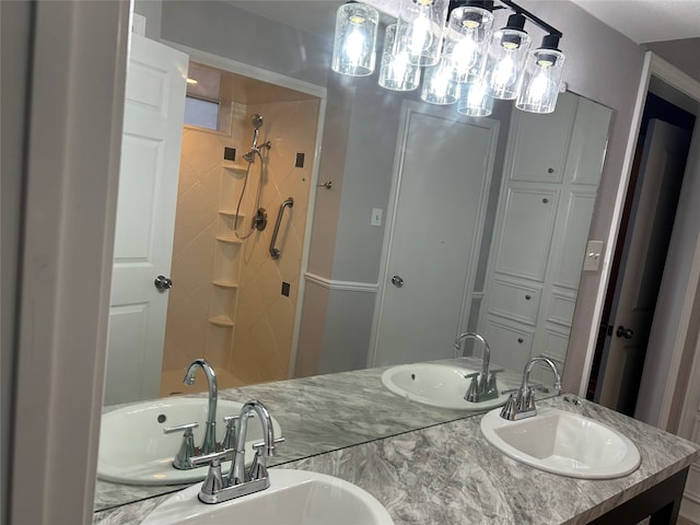 bathroom with vanity and a tile shower