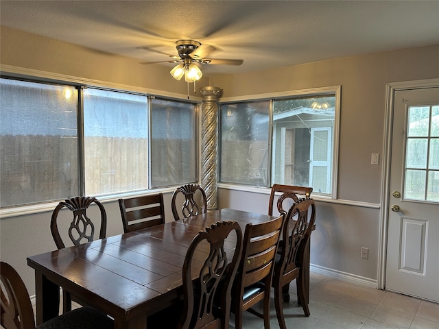 tiled dining space featuring ceiling fan and a textured ceiling