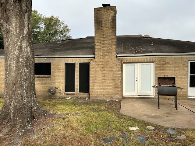 rear view of property with french doors and a patio area