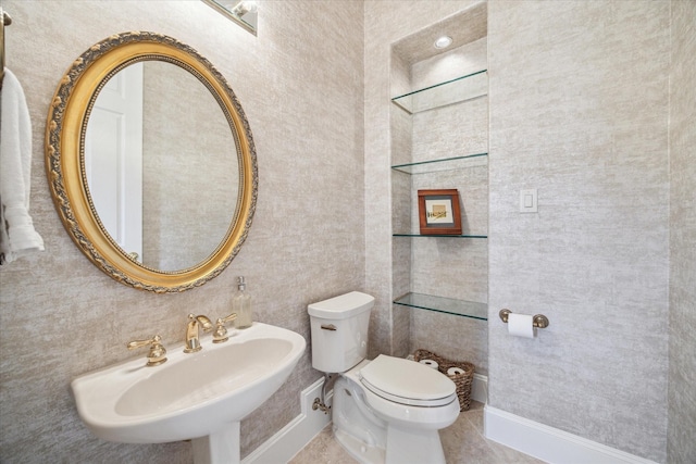 bathroom featuring sink, tile patterned floors, and toilet