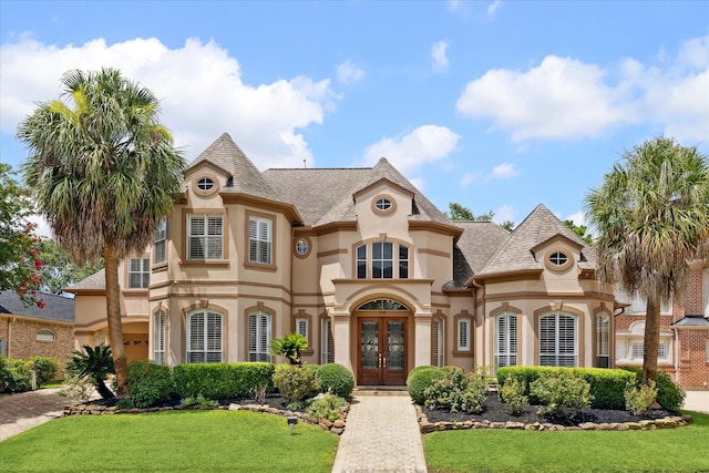 view of front facade with a front lawn and french doors