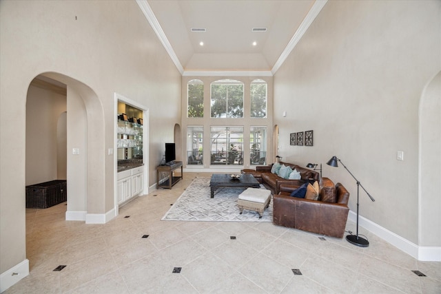 living room featuring a towering ceiling and light tile patterned floors