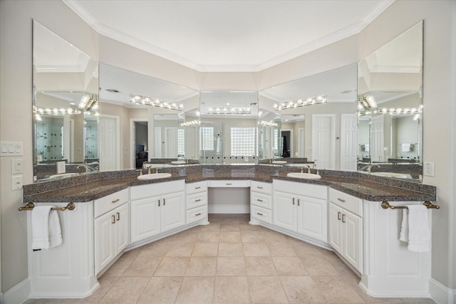 bathroom with vanity, crown molding, tile patterned floors, and walk in shower