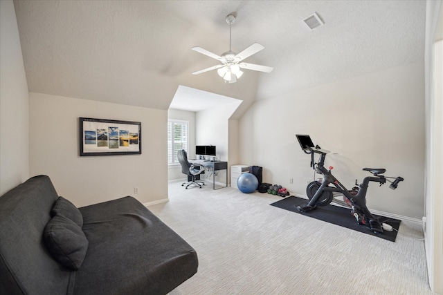 workout area featuring ceiling fan, vaulted ceiling, and light carpet