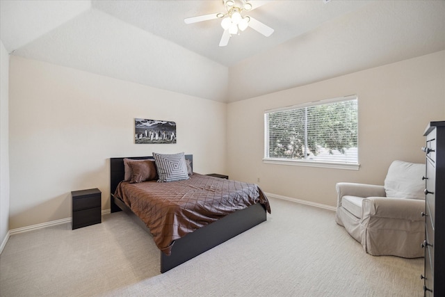 bedroom featuring ceiling fan, lofted ceiling, and light colored carpet