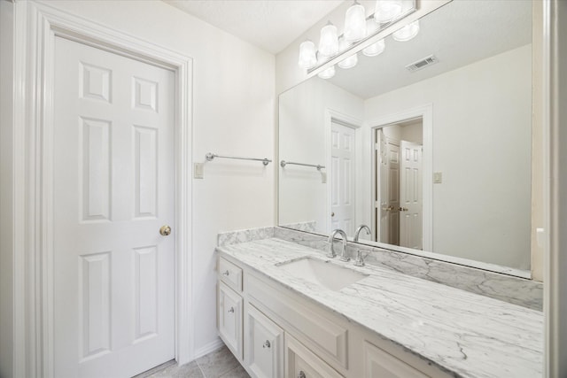 bathroom with vanity and tile patterned flooring