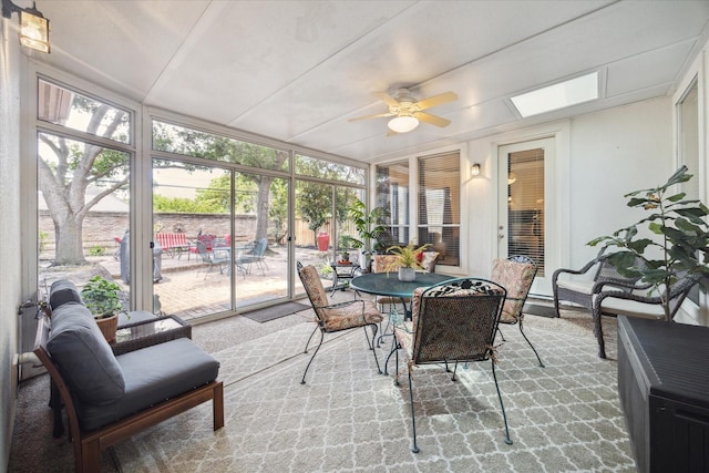 sunroom / solarium featuring ceiling fan