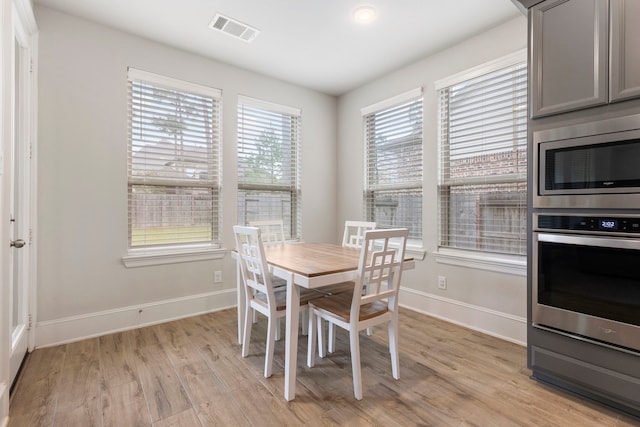 dining space with light hardwood / wood-style floors