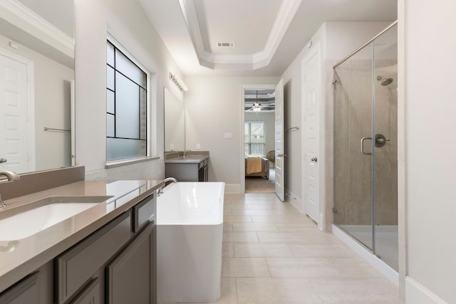 bathroom featuring vanity, independent shower and bath, tile patterned flooring, a tray ceiling, and ceiling fan