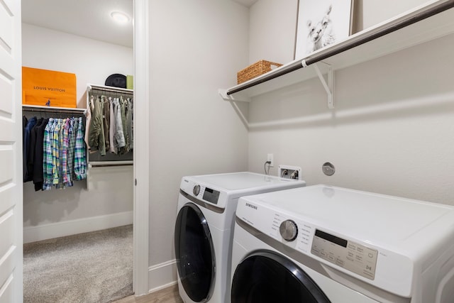 clothes washing area featuring carpet and washer and dryer