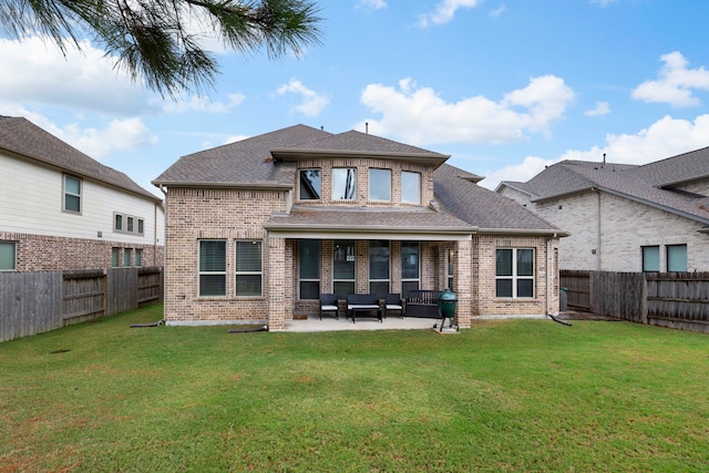 back of property featuring a patio area and a lawn